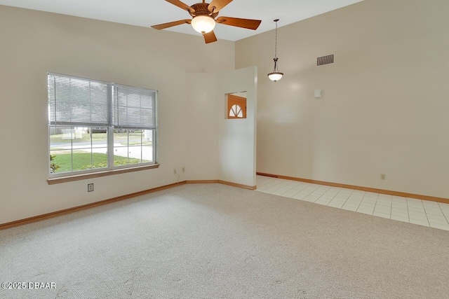 unfurnished room with light carpet, a ceiling fan, visible vents, and baseboards