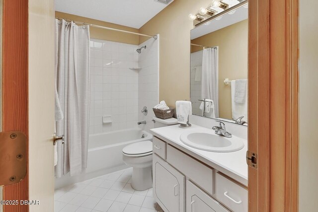 full bath with tile patterned floors, visible vents, toilet, vanity, and shower / tub combo