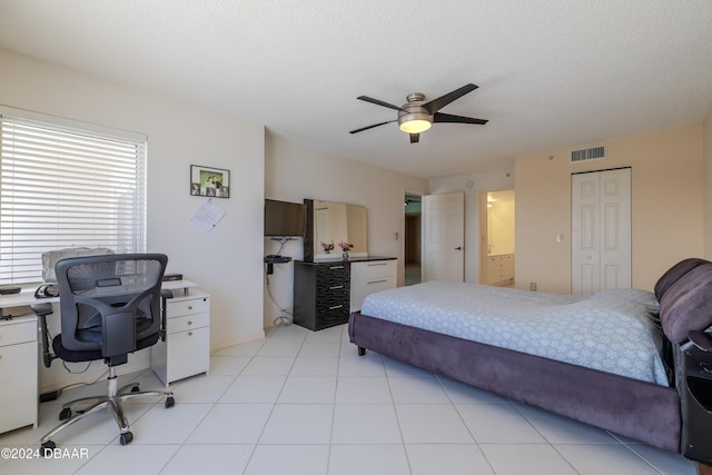 bedroom featuring ceiling fan, a closet, and a textured ceiling