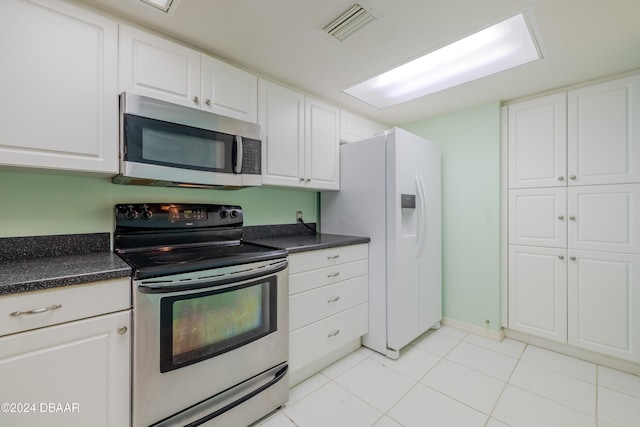 kitchen with white cabinetry, light tile patterned flooring, and stainless steel appliances