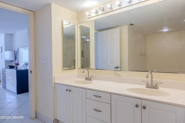 bathroom with tile patterned flooring and vanity