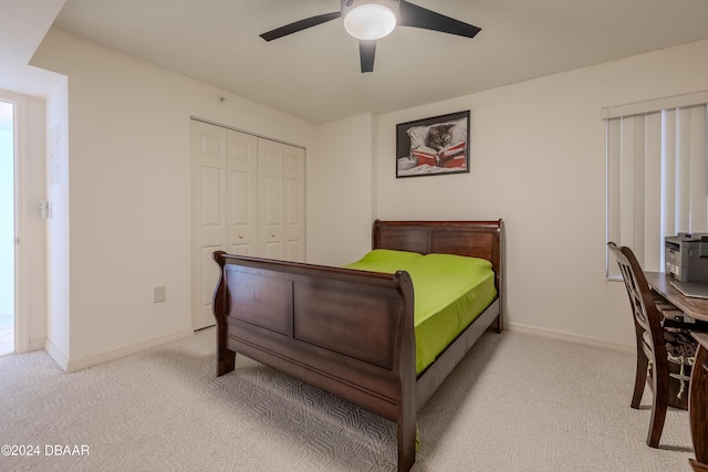 bedroom featuring ceiling fan, a closet, and light carpet