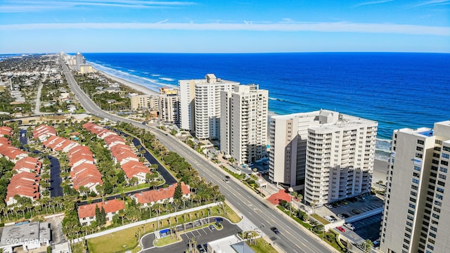 drone / aerial view featuring a water view and a view of the beach