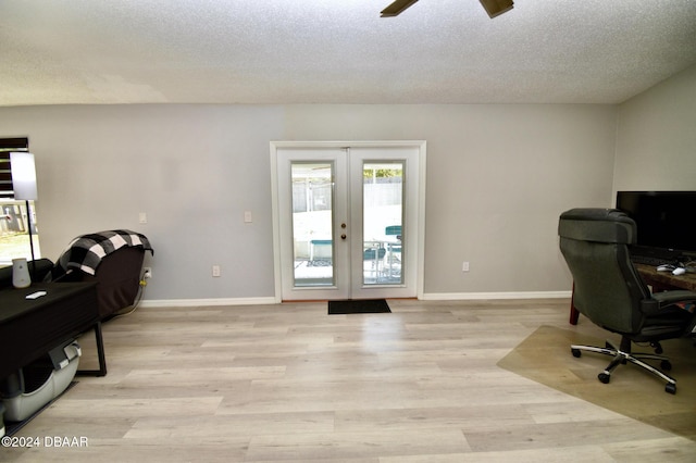 office featuring ceiling fan, light hardwood / wood-style floors, french doors, and a textured ceiling