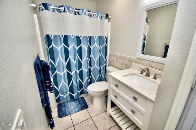 bathroom with tile patterned flooring, tile walls, vanity, a shower with curtain, and toilet