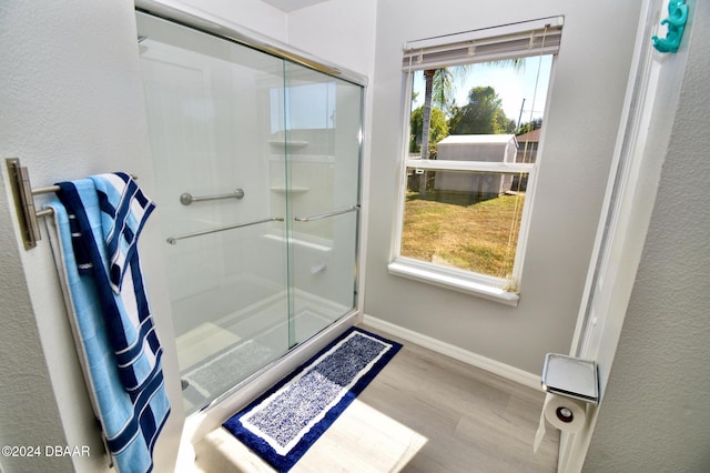 bathroom featuring wood-type flooring and walk in shower