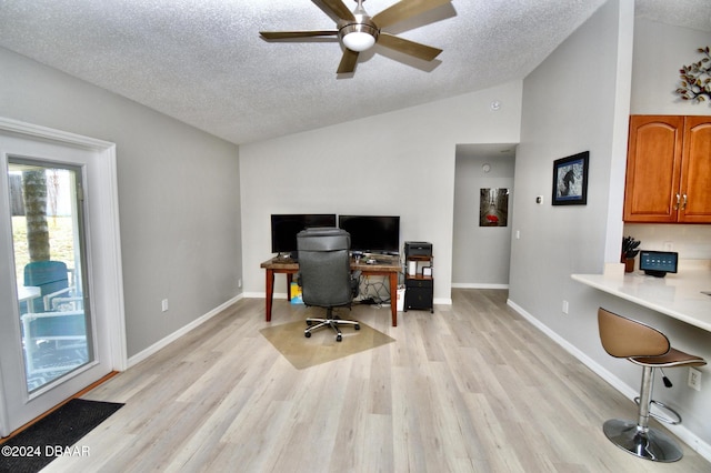 office featuring vaulted ceiling, ceiling fan, a textured ceiling, and light hardwood / wood-style floors