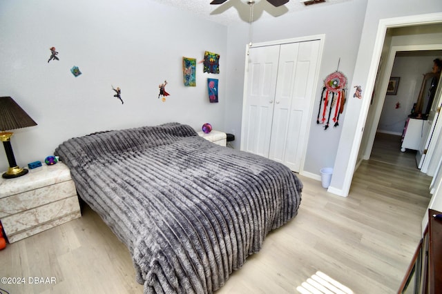 bedroom featuring ceiling fan, light hardwood / wood-style floors, and a closet