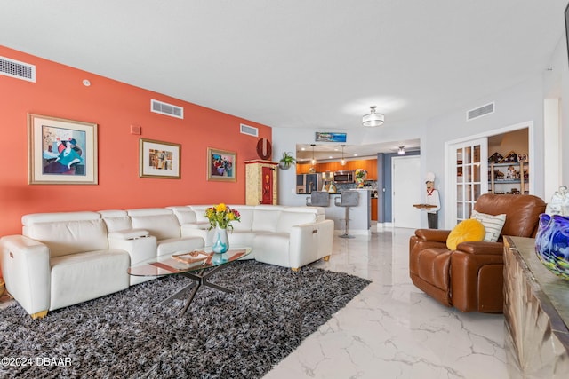 231 Riverside Dr Unit 1803-1, Daytona Beach, FL 32117 - living room featuring marble tiled flooring and an accent wall