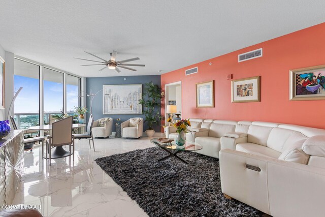 231 Riverside Dr Unit 1803-1, Daytona Beach, FL 32117 - living room with a ceiling fan, marble finish floors, and floor to ceiling windows