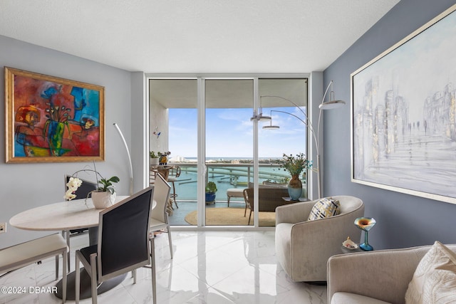 231 Riverside Dr Unit 1803-1, Daytona Beach, FL 32117 - dining space with a wall of windows, light marble finish floors, and a water view