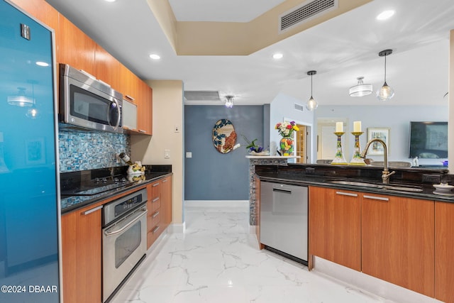 231 Riverside Dr Unit 1803-1, Daytona Beach, FL 32117 - kitchen featuring stainless steel appliances, a sink, modern cabinets, brown cabinets, and recessed lighting