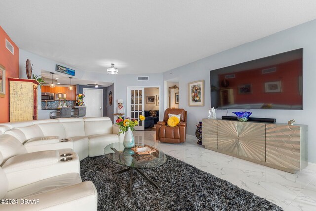 231 Riverside Dr Unit 1803-1, Daytona Beach, FL 32117 - living area with marble finish flooring and baseboards