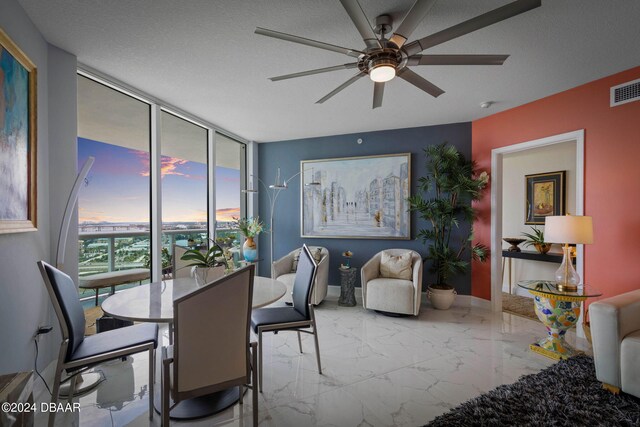 231 Riverside Dr Unit 1803-1, Daytona Beach, FL 32117 - dining room featuring a ceiling fan, a wall of windows, marble finish floors, and baseboards