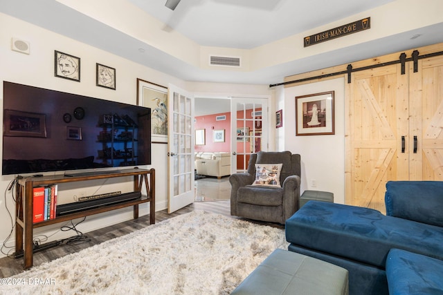 231 Riverside Dr Unit 1803-1, Daytona Beach, FL 32117 - living room featuring french doors, wood finished floors, a barn door, and baseboards