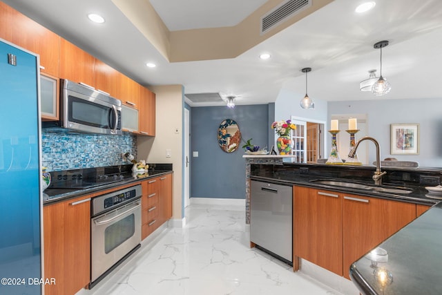 231 Riverside Dr Unit 1803-1, Daytona Beach, FL 32117 - kitchen with a sink, stainless steel appliances, baseboards, brown cabinets, and recessed lighting