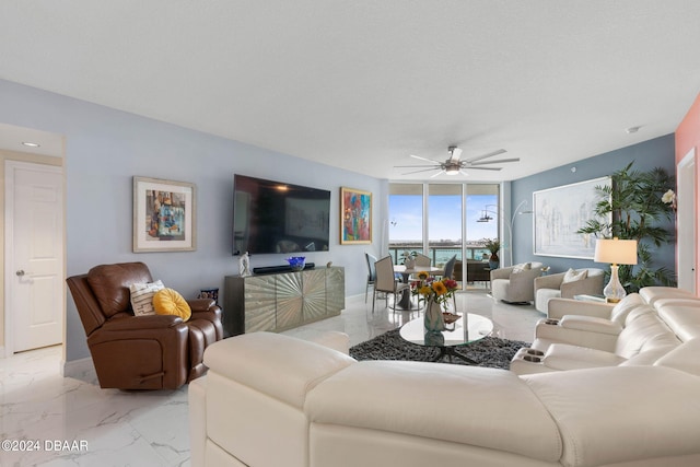 231 Riverside Dr Unit 1803-1, Daytona Beach, FL 32117 - living room with light marble finish floors, ceiling fan, and baseboards