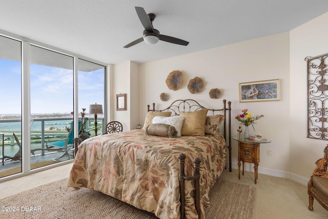 231 Riverside Dr Unit 1803-1, Daytona Beach, FL 32117 - bedroom featuring access to outside, a wall of windows, carpet, baseboards, and ceiling fan