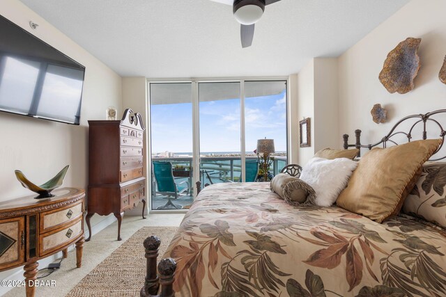 231 Riverside Dr Unit 1803-1, Daytona Beach, FL 32117 - bedroom featuring access to outside, light colored carpet, a wall of windows, and a ceiling fan