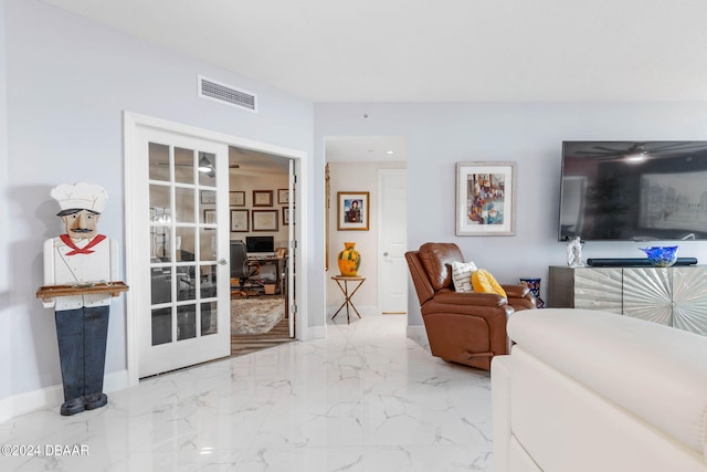231 Riverside Dr Unit 1803-1, Daytona Beach, FL 32117 - living room with a desk, baseboards, and marble tiled floors