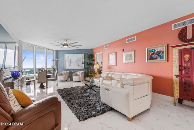 231 Riverside Dr Unit 1803-1, Daytona Beach, FL 32117 - living room with a ceiling fan, light marble finish floors, expansive windows, and baseboards