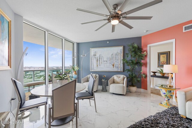 231 Riverside Dr Unit 1803-1, Daytona Beach, FL 32117 - dining space with a wall of windows, a ceiling fan, marble finish flooring, and baseboards