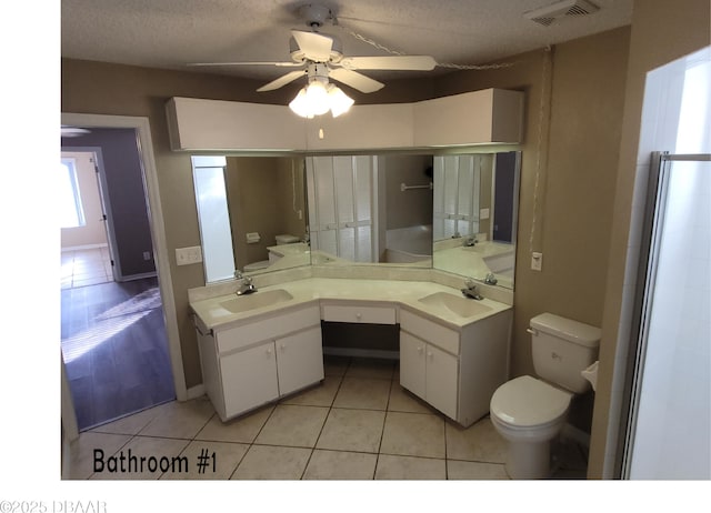 bathroom with visible vents, a sink, toilet, and tile patterned floors