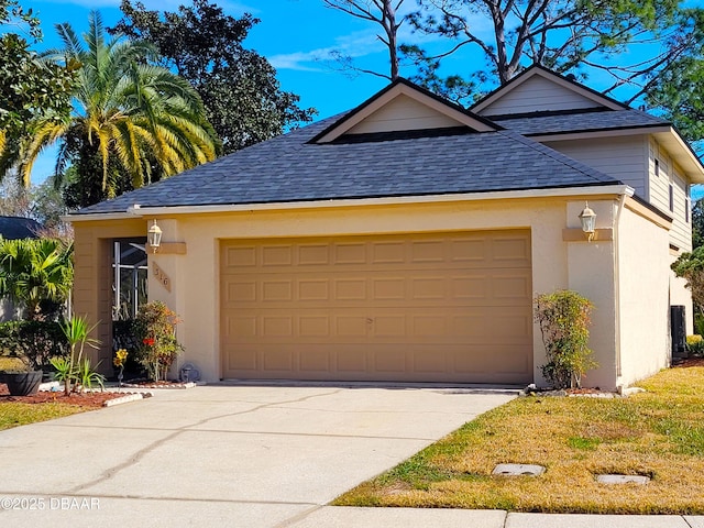 view of front facade with a garage, driveway, a shingled roof, and stucco siding