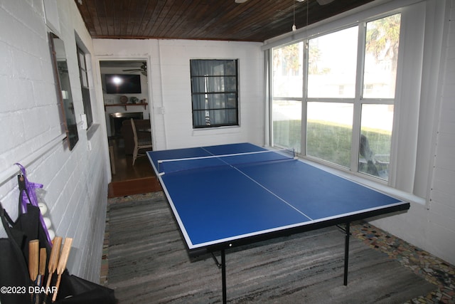 recreation room featuring dark hardwood / wood-style flooring, wood ceiling, and ceiling fan