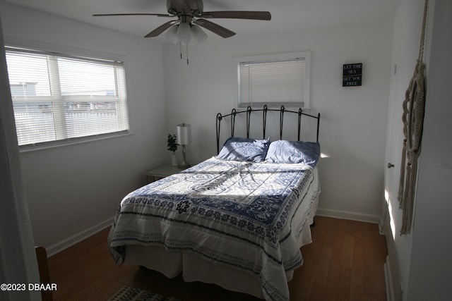 bedroom with dark wood-type flooring and ceiling fan