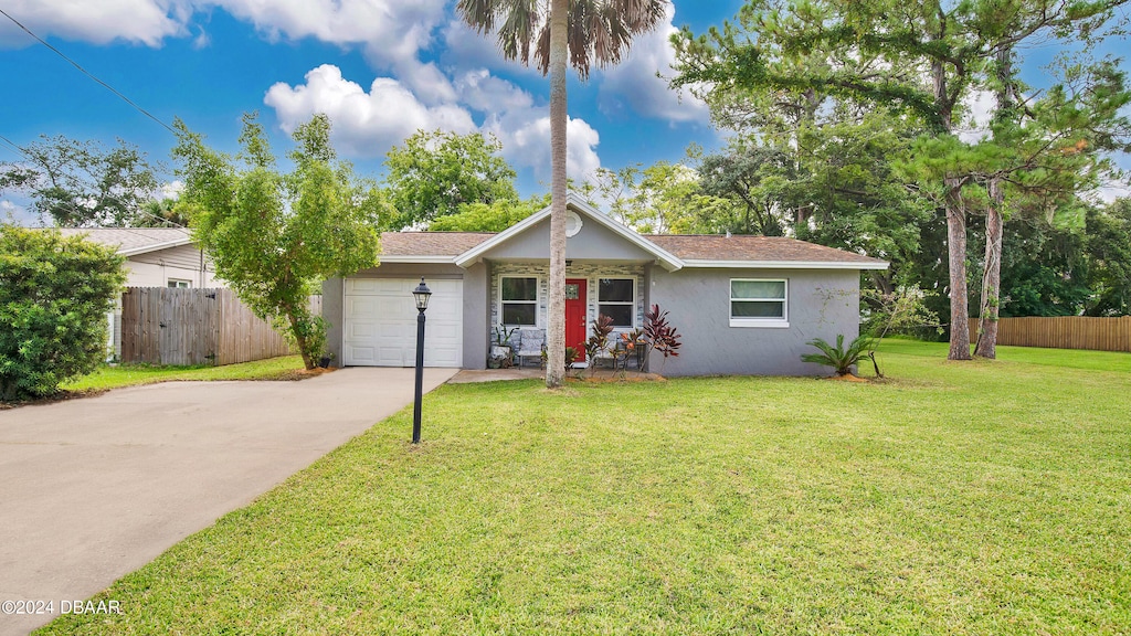 ranch-style house with driveway, an attached garage, fence, and a front yard