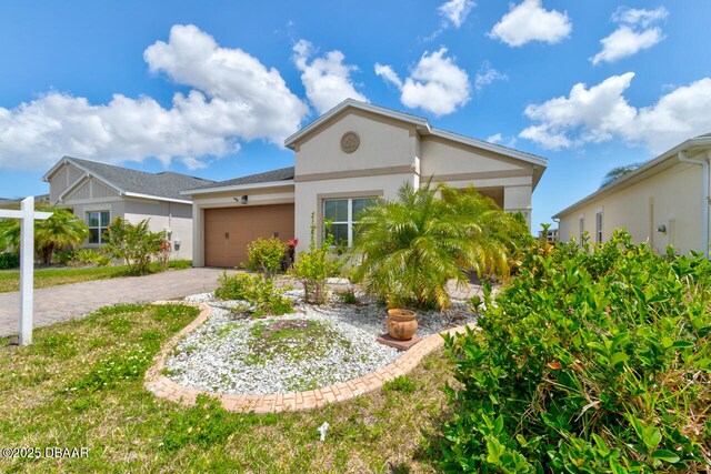 5427 Estero Loop, Port Orange, FL 32128 - view of front facade with decorative driveway, stucco siding, and an attached garage