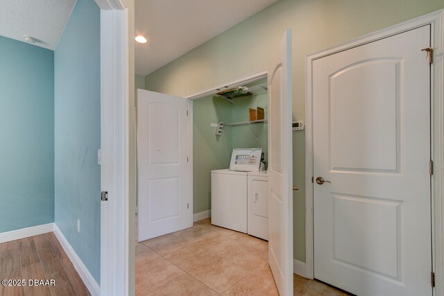 5427 Estero Loop, Port Orange, FL 32128 - laundry area with light tile patterned flooring, washing machine and dryer, baseboards, and laundry area