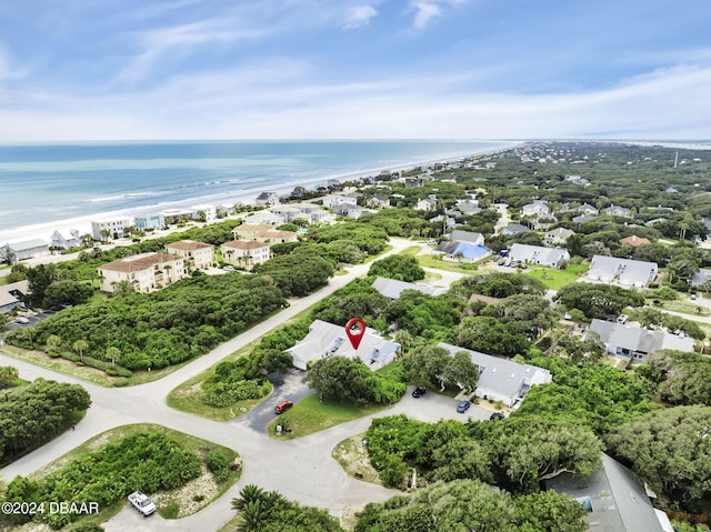 drone / aerial view featuring a beach view and a water view