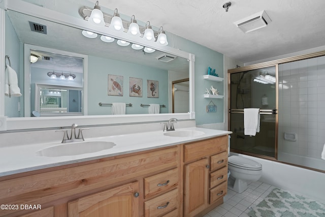 full bathroom with vanity, shower / bath combination with glass door, tile patterned flooring, toilet, and a textured ceiling