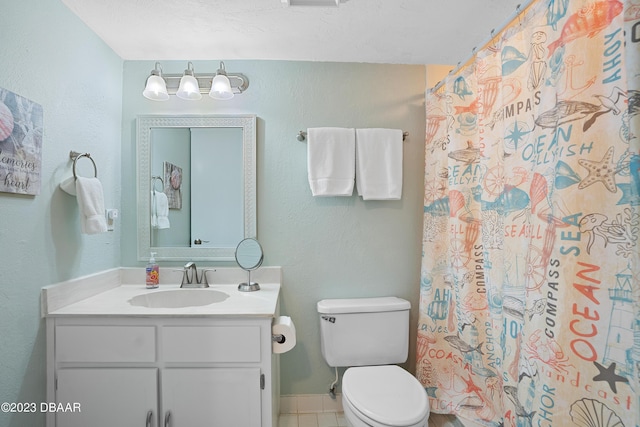 bathroom featuring a shower with curtain, vanity, toilet, and tile patterned flooring