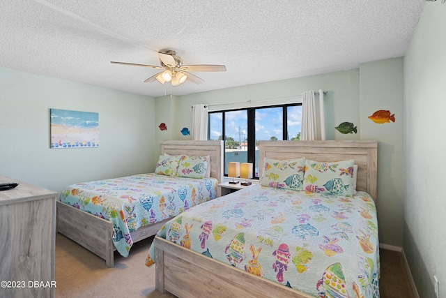 carpeted bedroom with a textured ceiling and ceiling fan