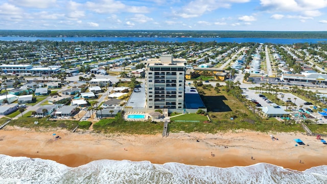 birds eye view of property featuring a beach view and a water view