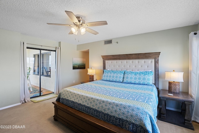 carpeted bedroom with access to outside, ceiling fan, and a textured ceiling