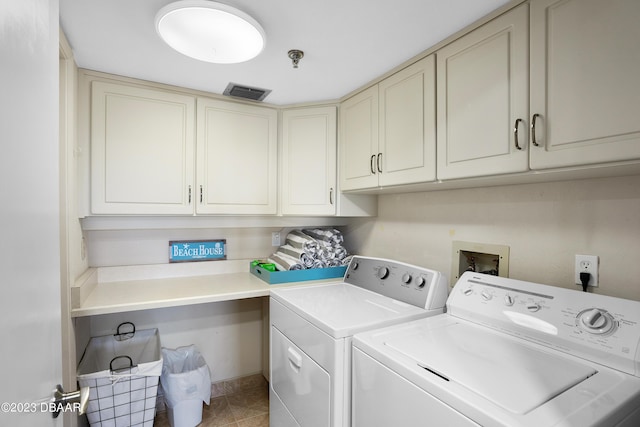 laundry room featuring light tile patterned flooring, cabinets, and independent washer and dryer