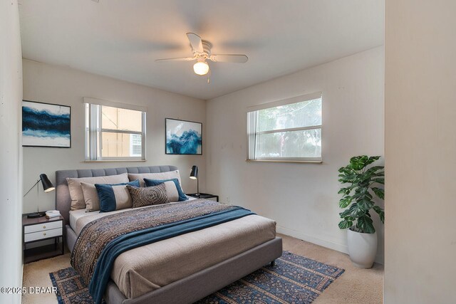 unfurnished bedroom with light carpet, a closet, and ceiling fan