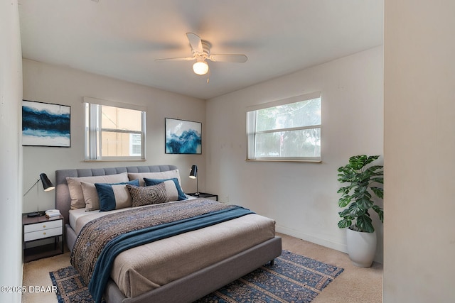 bedroom featuring light colored carpet and ceiling fan