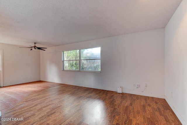 spare room featuring ceiling fan, hardwood / wood-style floors, and a textured ceiling