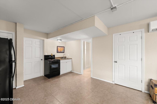 kitchen featuring sink, a wall mounted air conditioner, white cabinets, and black appliances