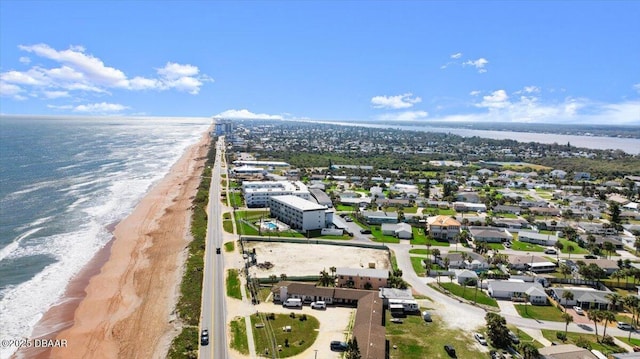 drone / aerial view with a water view and a beach view