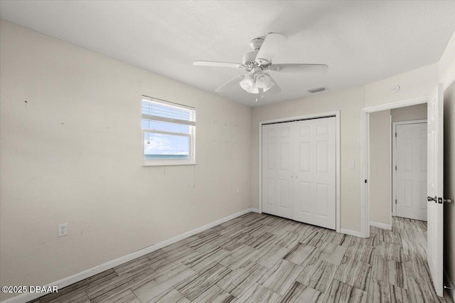 unfurnished bedroom featuring a closet and ceiling fan