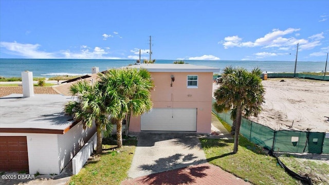 exterior space with a water view and a garage