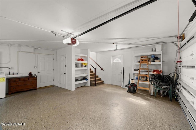 garage featuring a garage door opener and washer / dryer