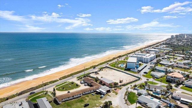 drone / aerial view with a beach view and a water view