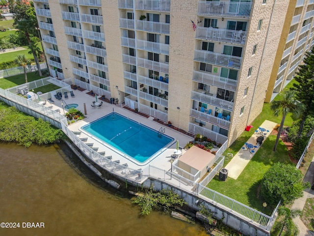 view of pool with a patio area and a water view